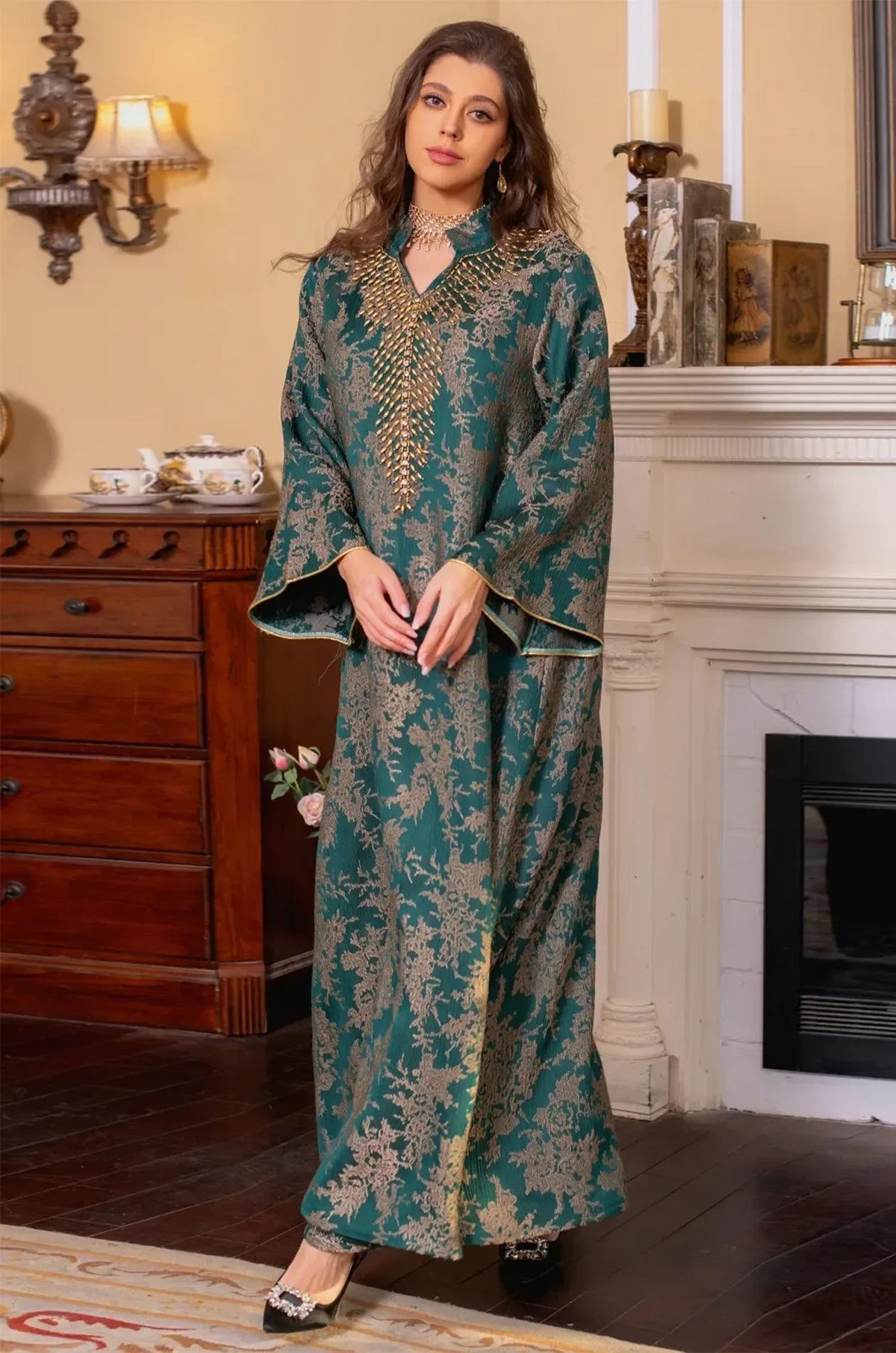 A dynamic full-body shot of the model in the dark green Estel kaftan, highlighting the movement of the jacquard fabric.