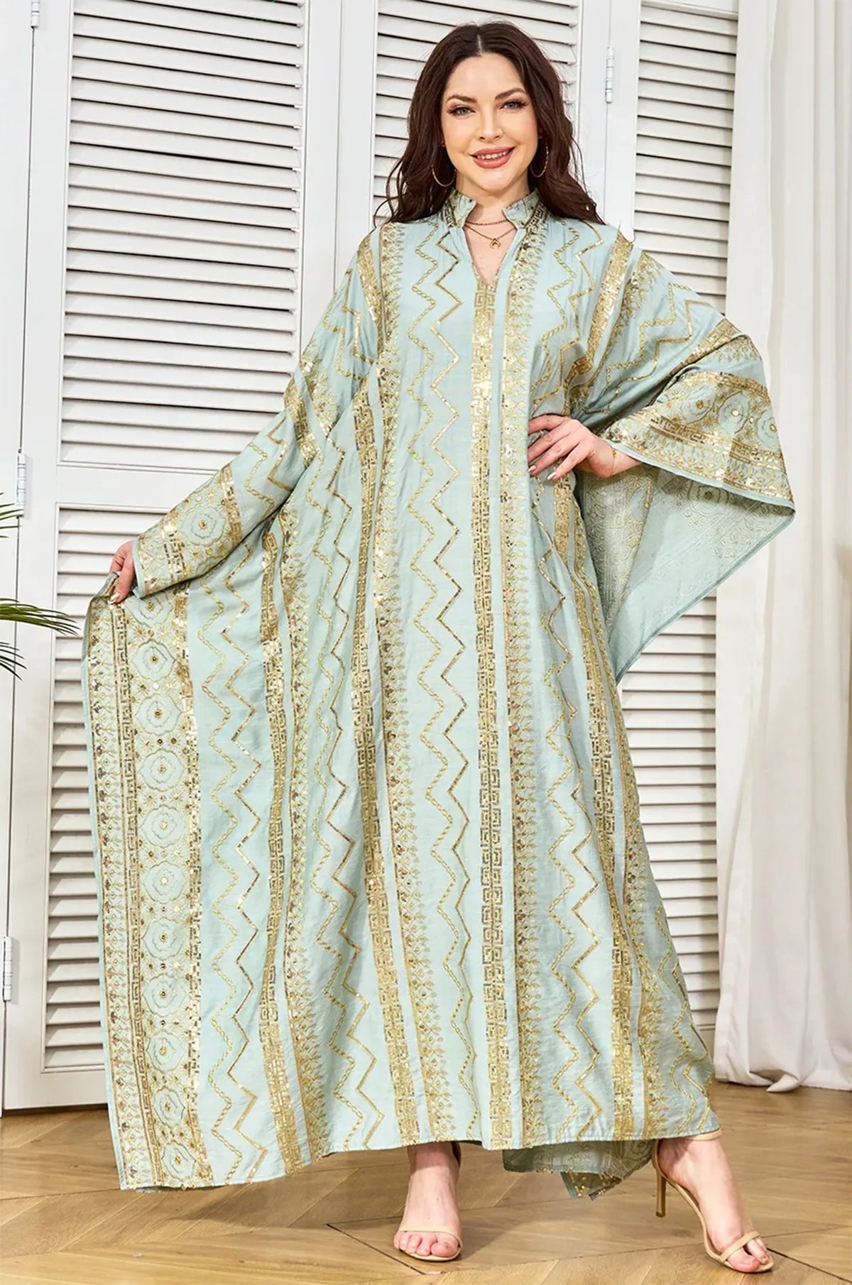High-angle shot showing the movement and drape of the Delphin light green fabric.