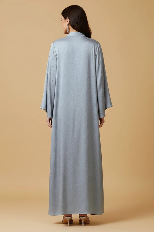 Back view of the Elani modest dress showing seamless satin flow and embellished shoulders.