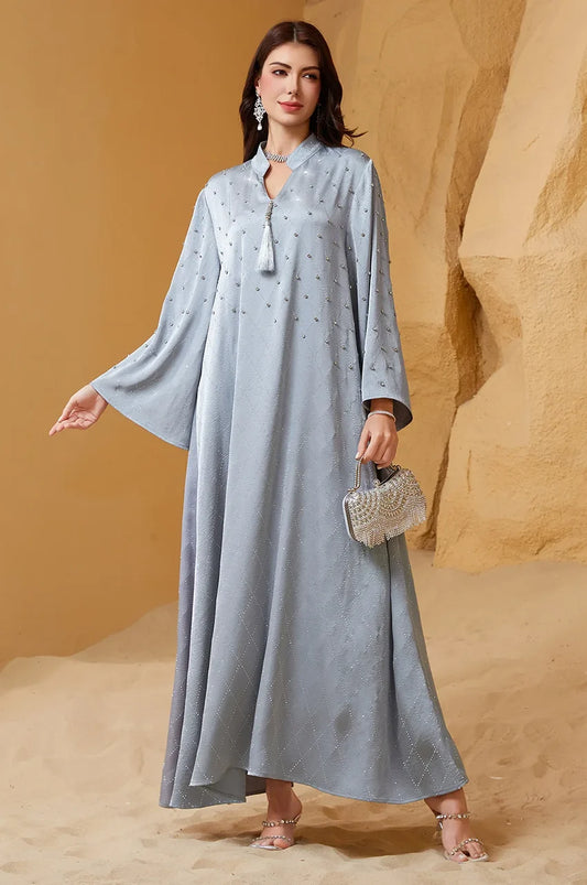 Model walking in Elani lavender gray kaftan displaying fabric movement and hemline.