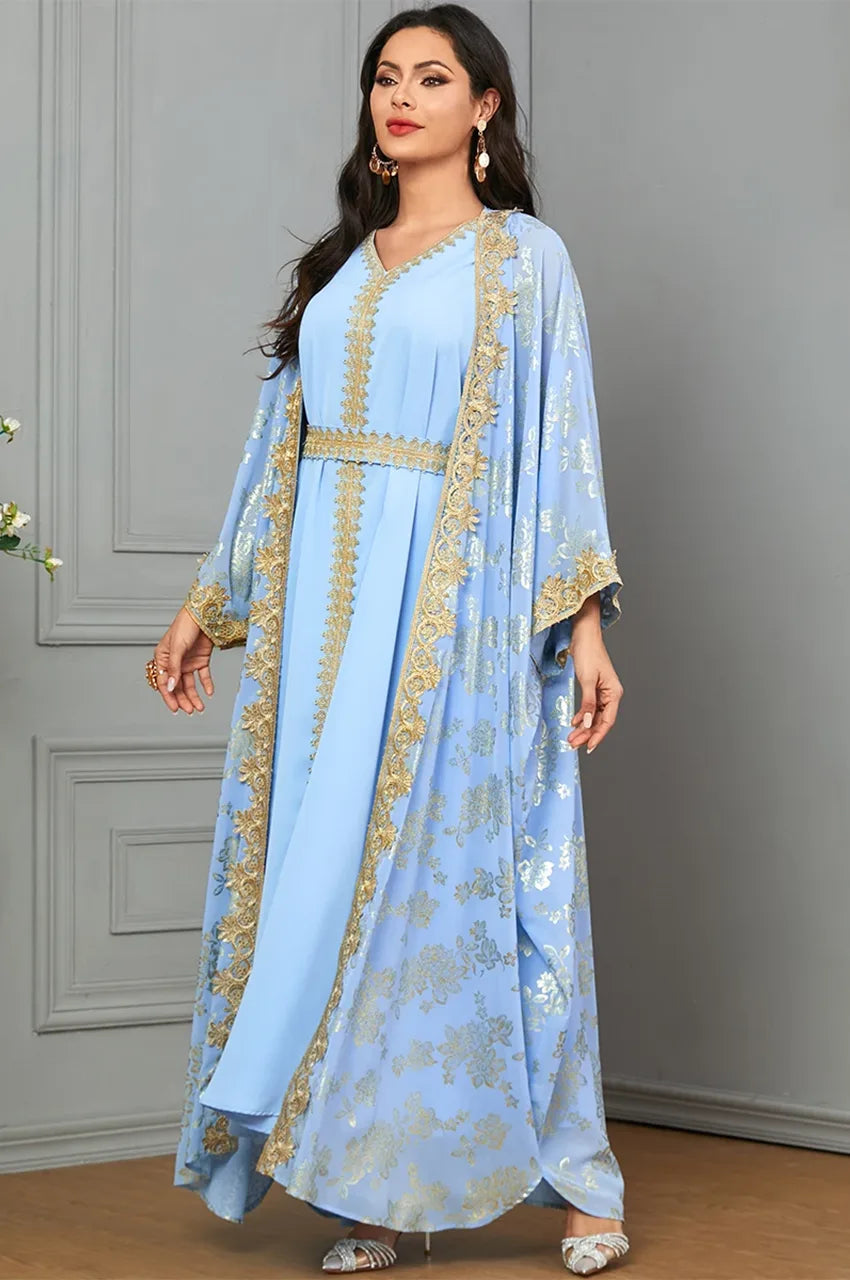 Elegant pose in a light blue and gold kaftan dress, perfect for wedding guests.