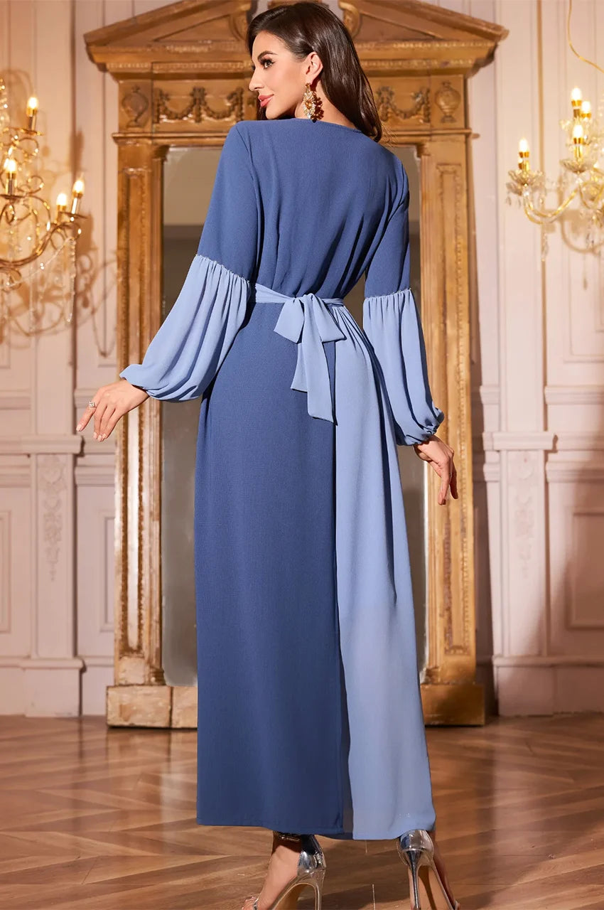 Rear angle of blue modest dress showing flowy fabric and structured fit.