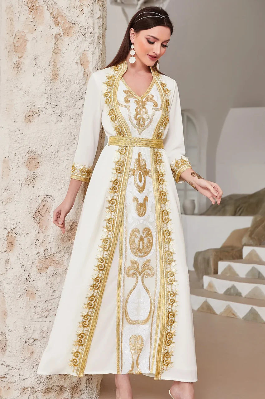 Elegant lifestyle shot of the SORAI white chiffon kaftan dress in a Mediterranean setting.