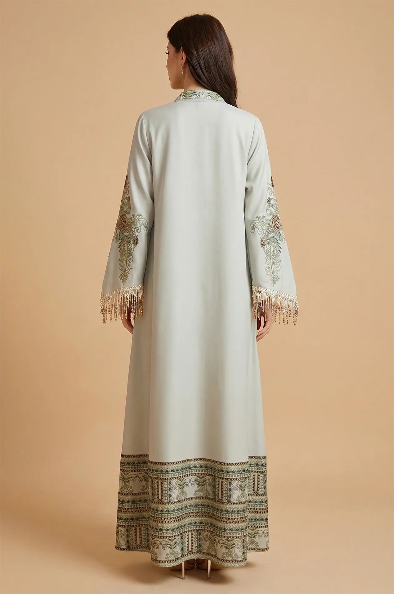 Rear view of Eliah luxury caftan showing embroidery on sleeves and collar.