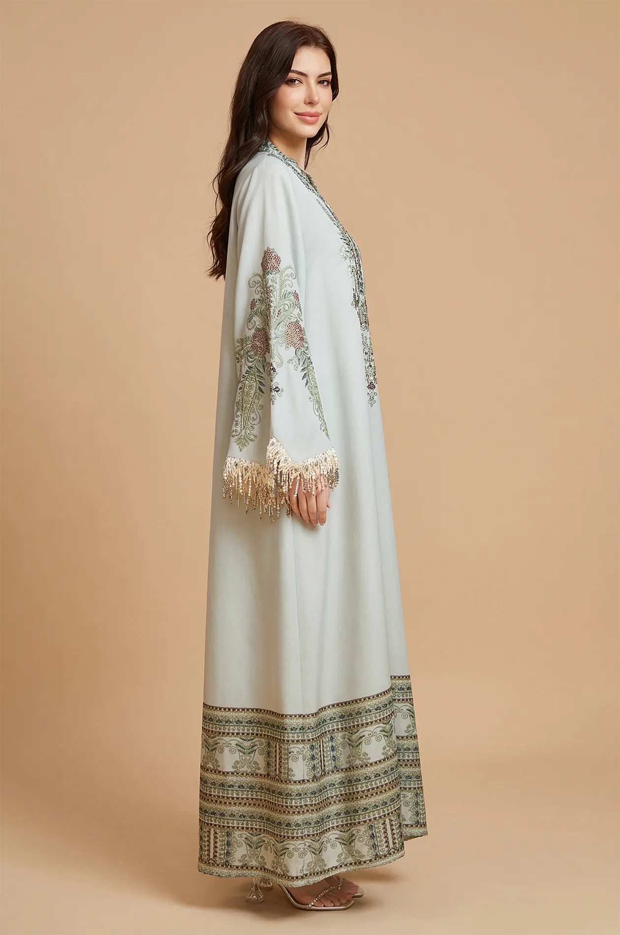 Side profile of the Eliah kaftan highlighting the beaded tassel sleeve detail.