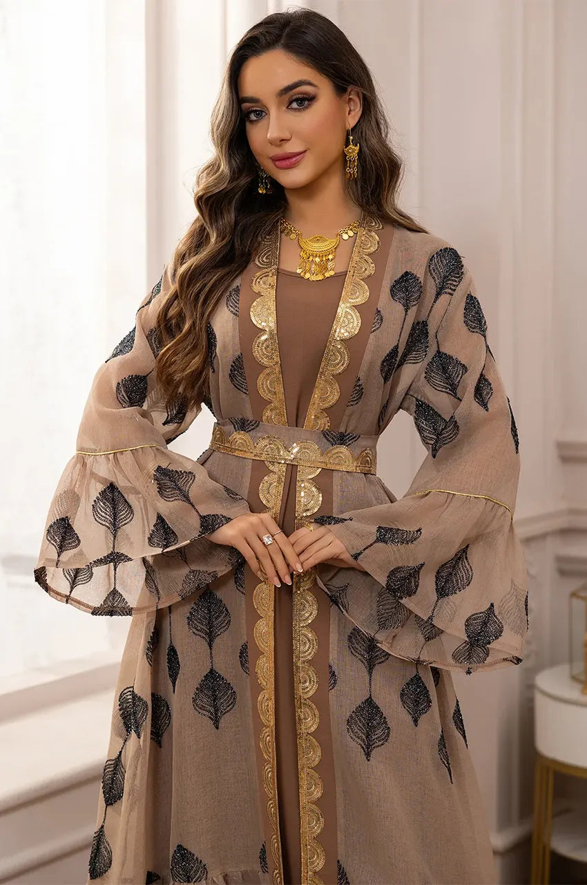 Model showing the wide bell sleeves and gold detailing of the Elsia kaftan.