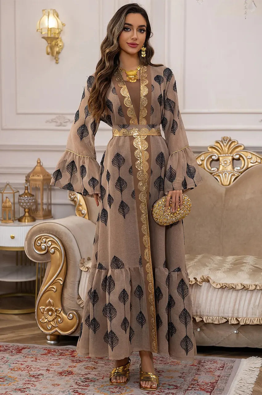 Lifestyle shot of the ELSIA khaki kaftan styled for a formal wedding or Eid celebration.