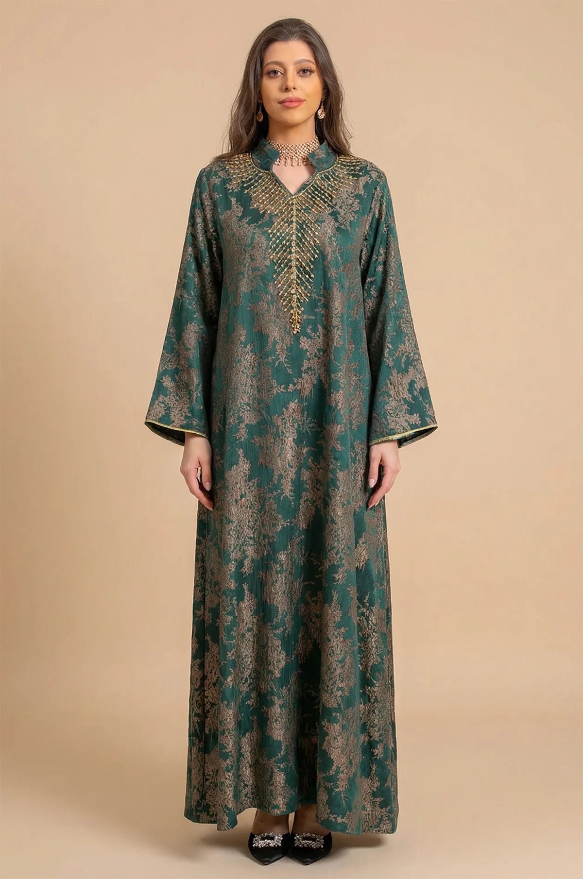 Full-length front view of the Estel dark green jacquard kaftan with gold floral patterns on a neutral beige studio background.