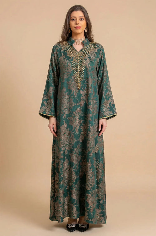 Full-length front view of the Estel dark green jacquard kaftan with gold floral patterns on a neutral beige studio background.