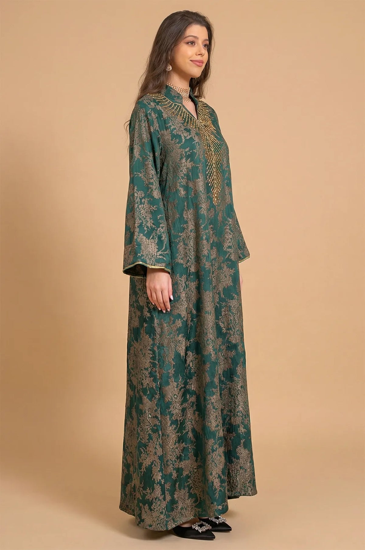 Side three-quarter profile of the Estel dark green kaftan showing the elegant drape and butterfly sleeves in a studio setting.