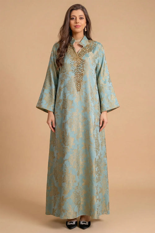 Full-length front view of the Estel light blue jacquard kaftan with gold floral patterns on a neutral beige studio background.