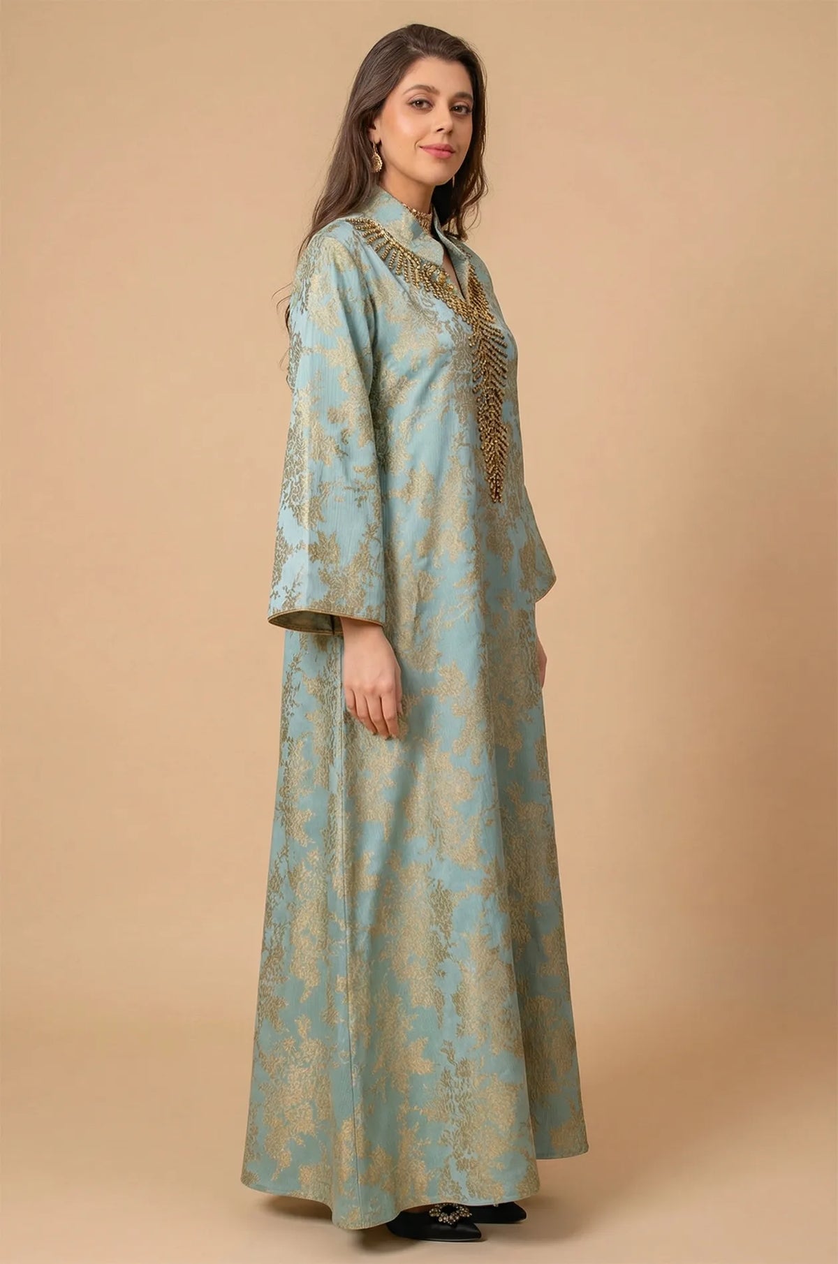 Side profile view of the Estel light blue kaftan showing the elegant drape and wide bell sleeves in a studio setting.