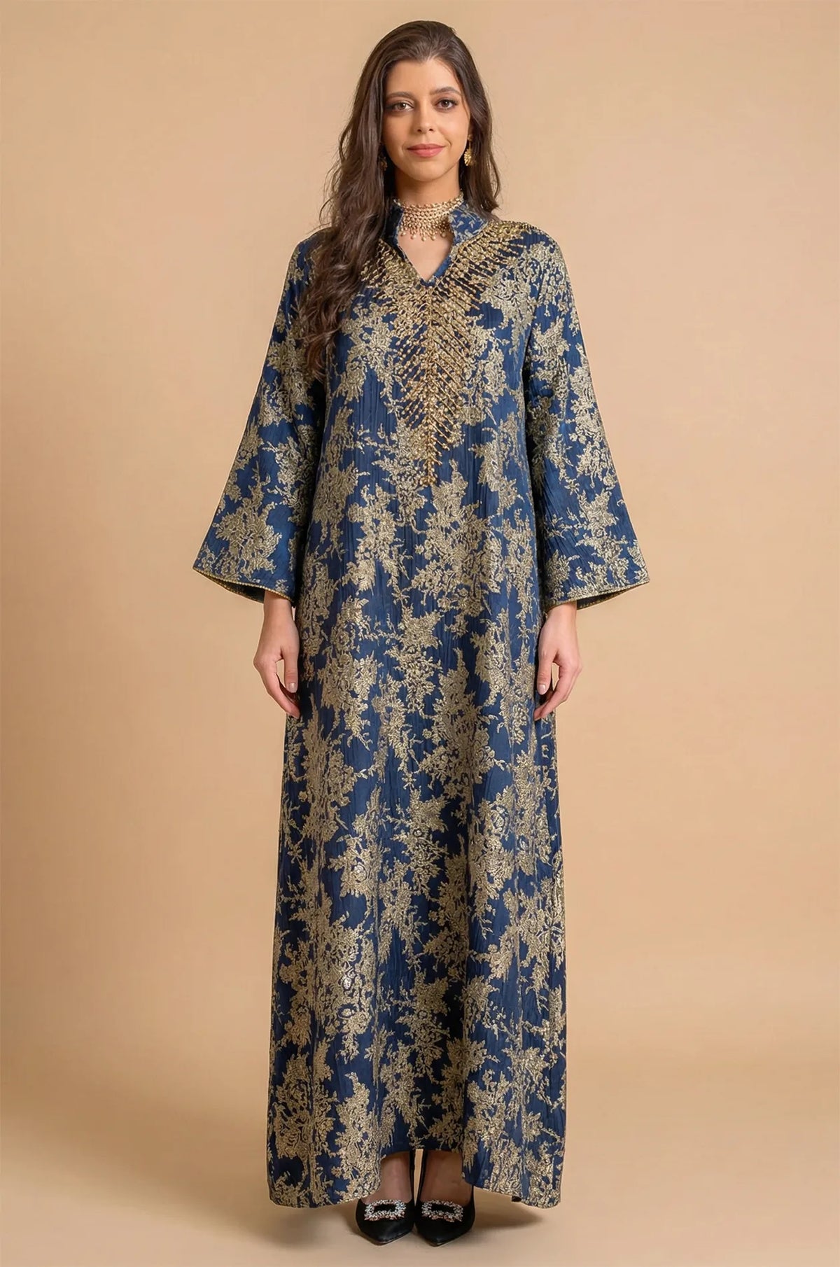 Full-length front view of the Estel navy blue jacquard kaftan with gold floral patterns on a solid beige studio background.