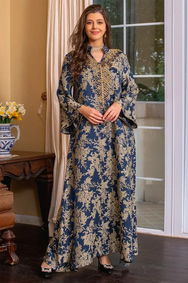 Full-body shot of the model walking in the navy blue Estel kaftan, highlighting the movement of the butterfly sleeves.