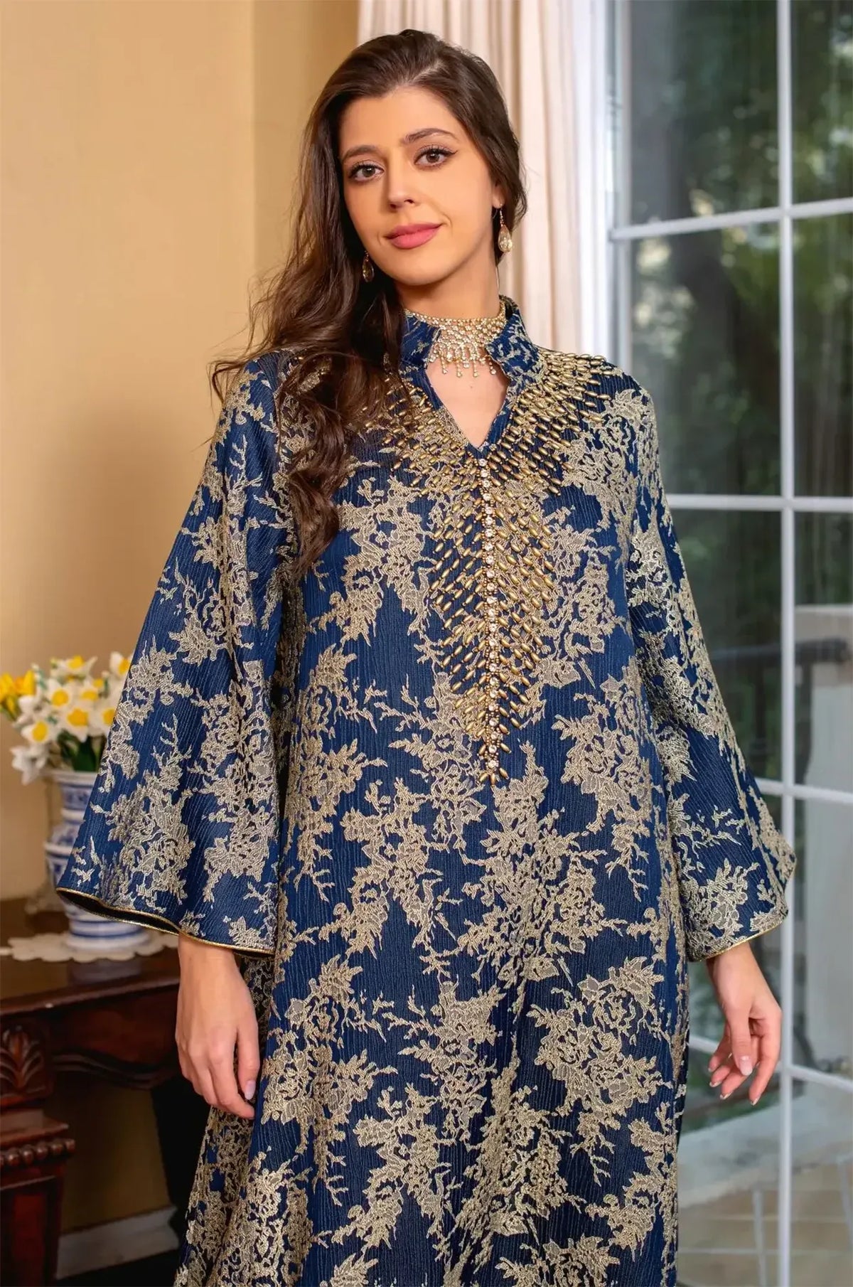Mid-shot of the Estel navy blue kaftan emphasizing the volume of the butterfly bell sleeves and the detailed bodice embroidery.