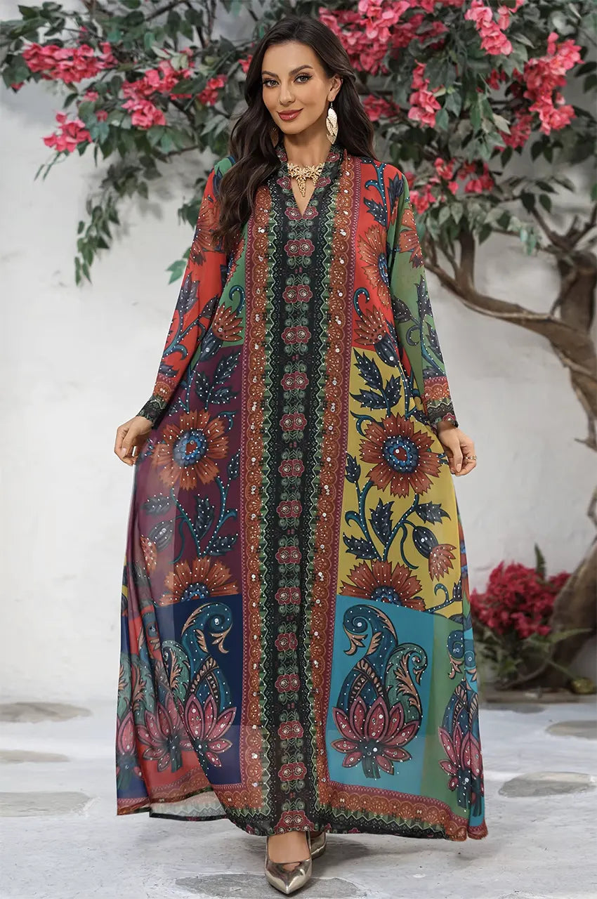 Full length shot of Fariya colorful kaftan styled with gold accessories in a garden setting.