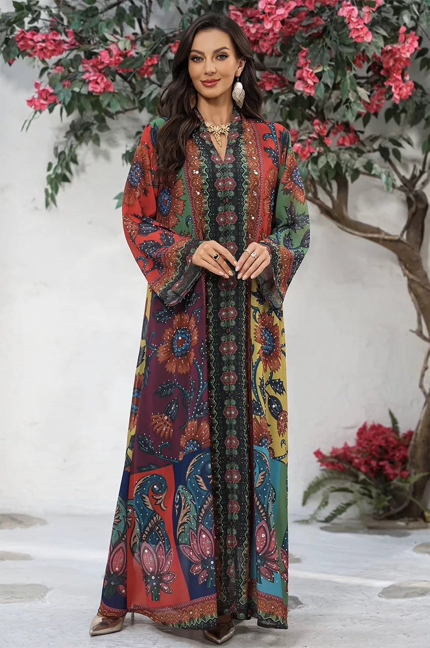 Elegant full body pose of the Fariya colorful kaftan against a floral background.