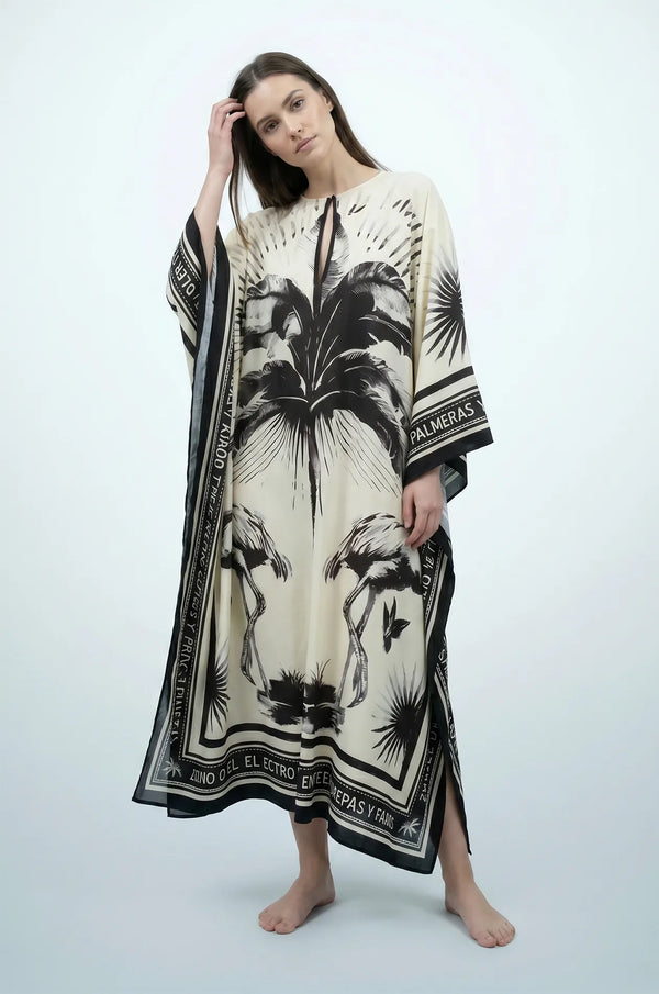 Woman wearing black and cream flamingo print kaftan with kimono sleeves
