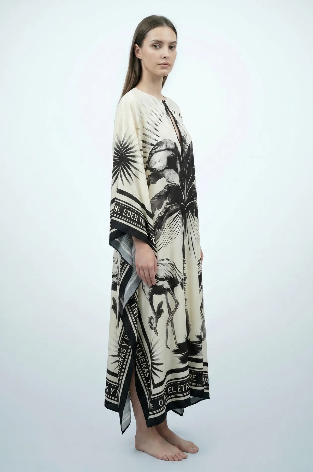 Side profile of Andra flamingo kaftan showing flowing drape