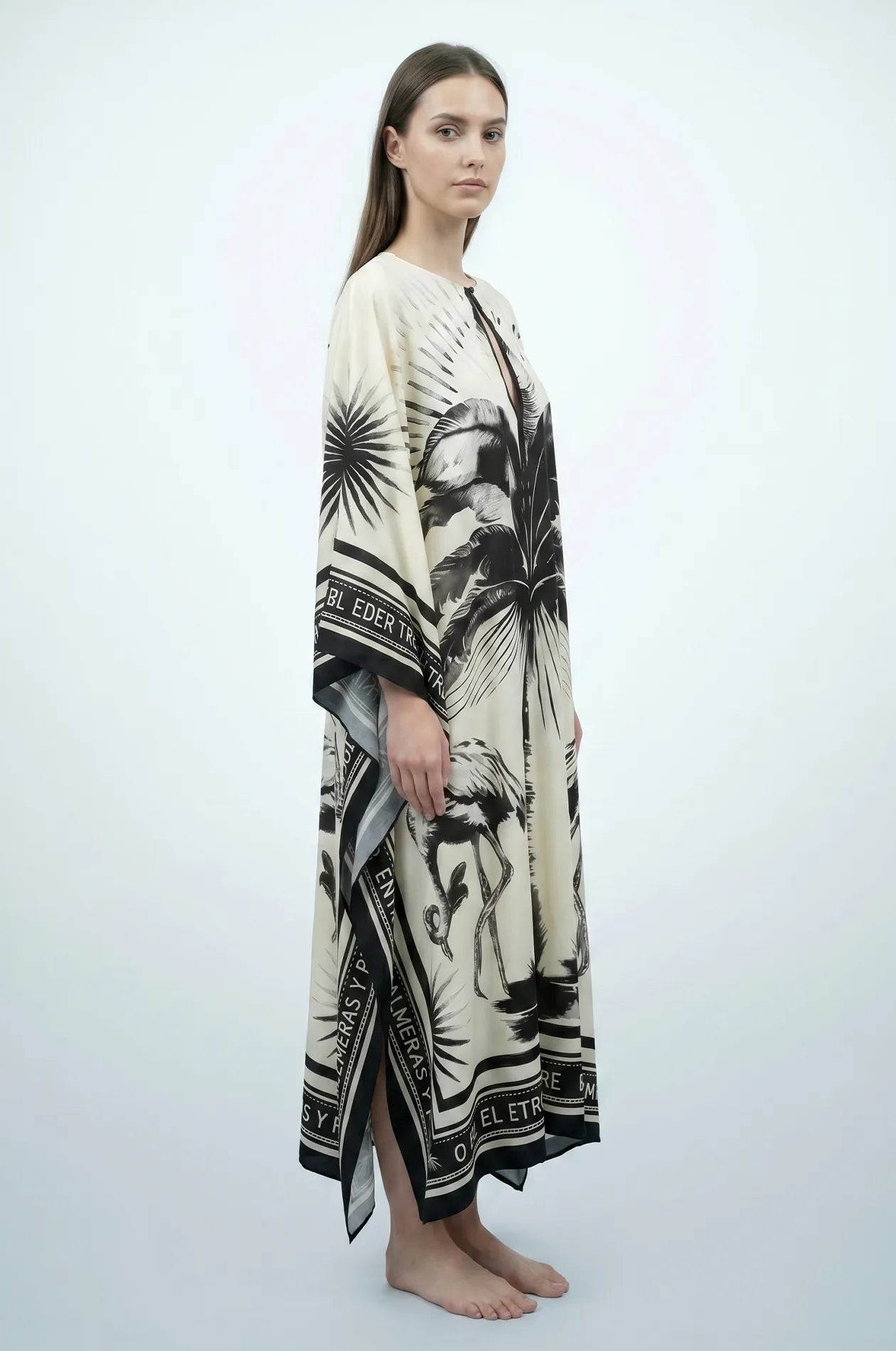 Side profile of Andra flamingo kaftan showing flowing drape