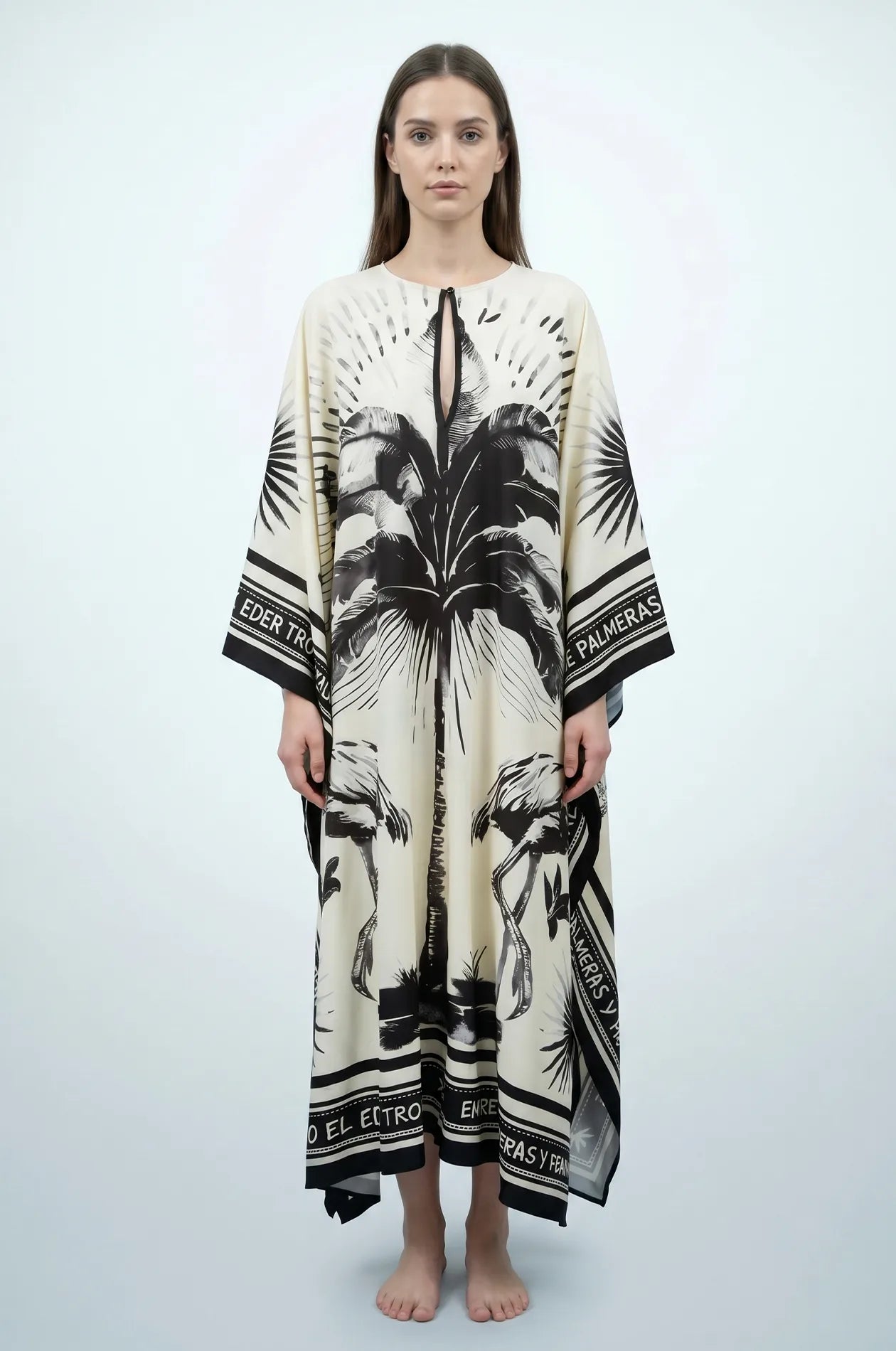 Full length studio front view of Andra flamingo palm print kaftan