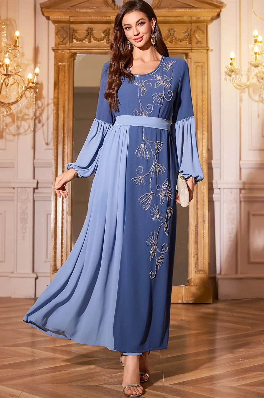 Zaria dress in motion showing the fluid drape of the side accordion pleats.