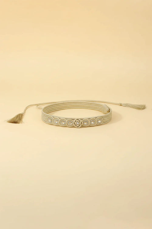 Coiled champagne gold braided waist belt showing flexibility and adjustable rope closure.