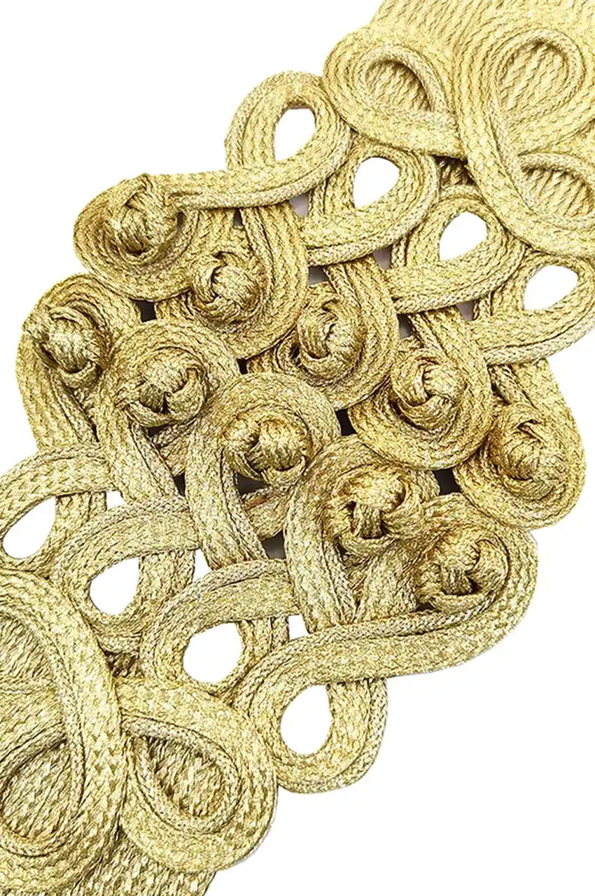 Macro detail of the raised gold cord embroidery and knotwork on the sash belt.