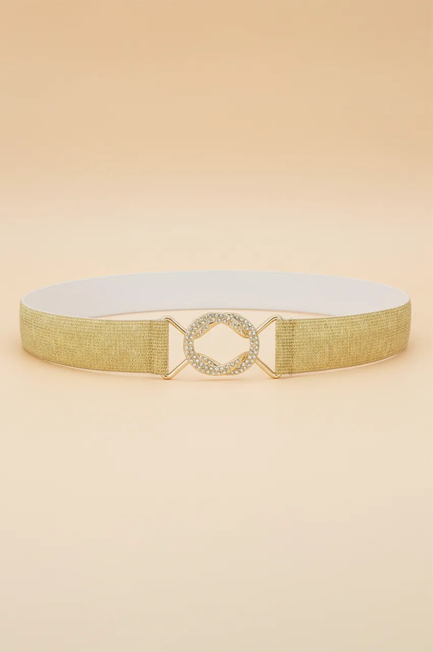 Front view of the gold metallic elastic waist belt with crystal buckle on beige background.