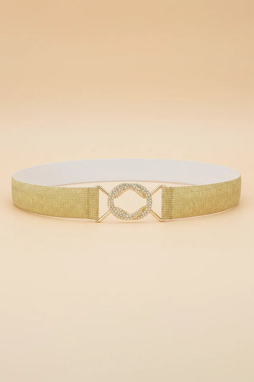 Front view of the gold metallic elastic waist belt with crystal buckle on beige background.