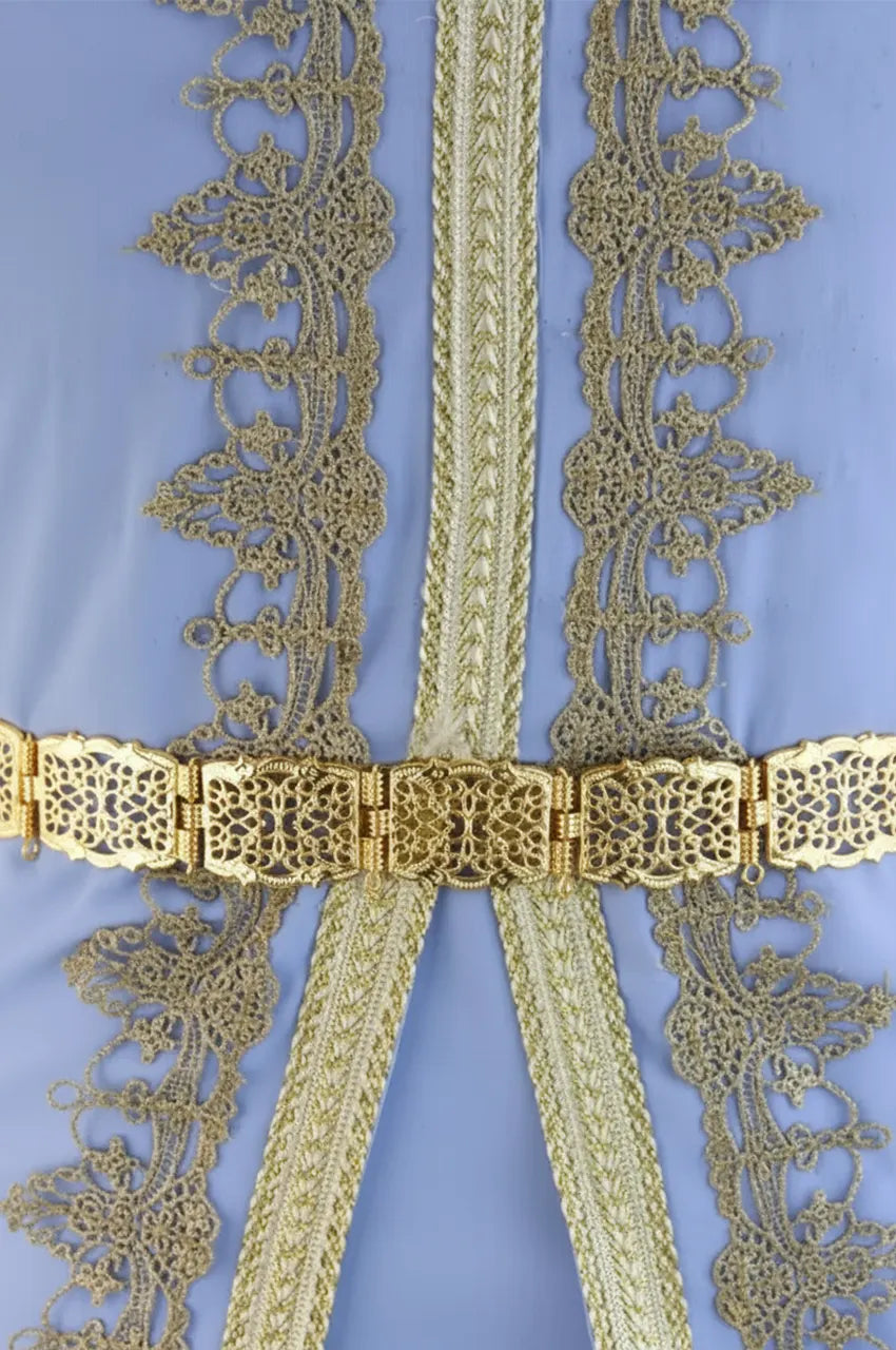 Gold square filigree belt cinched over a light blue embroidered Moroccan Kaftan.