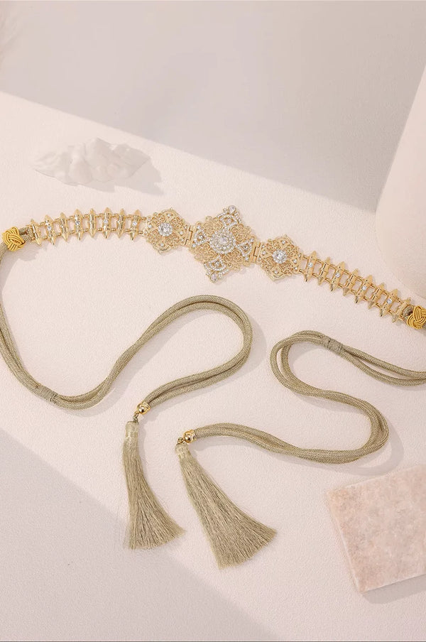 Gold Geometric Rhinestone Link Belt laid flat to showcase the spike design and adjustable closure.