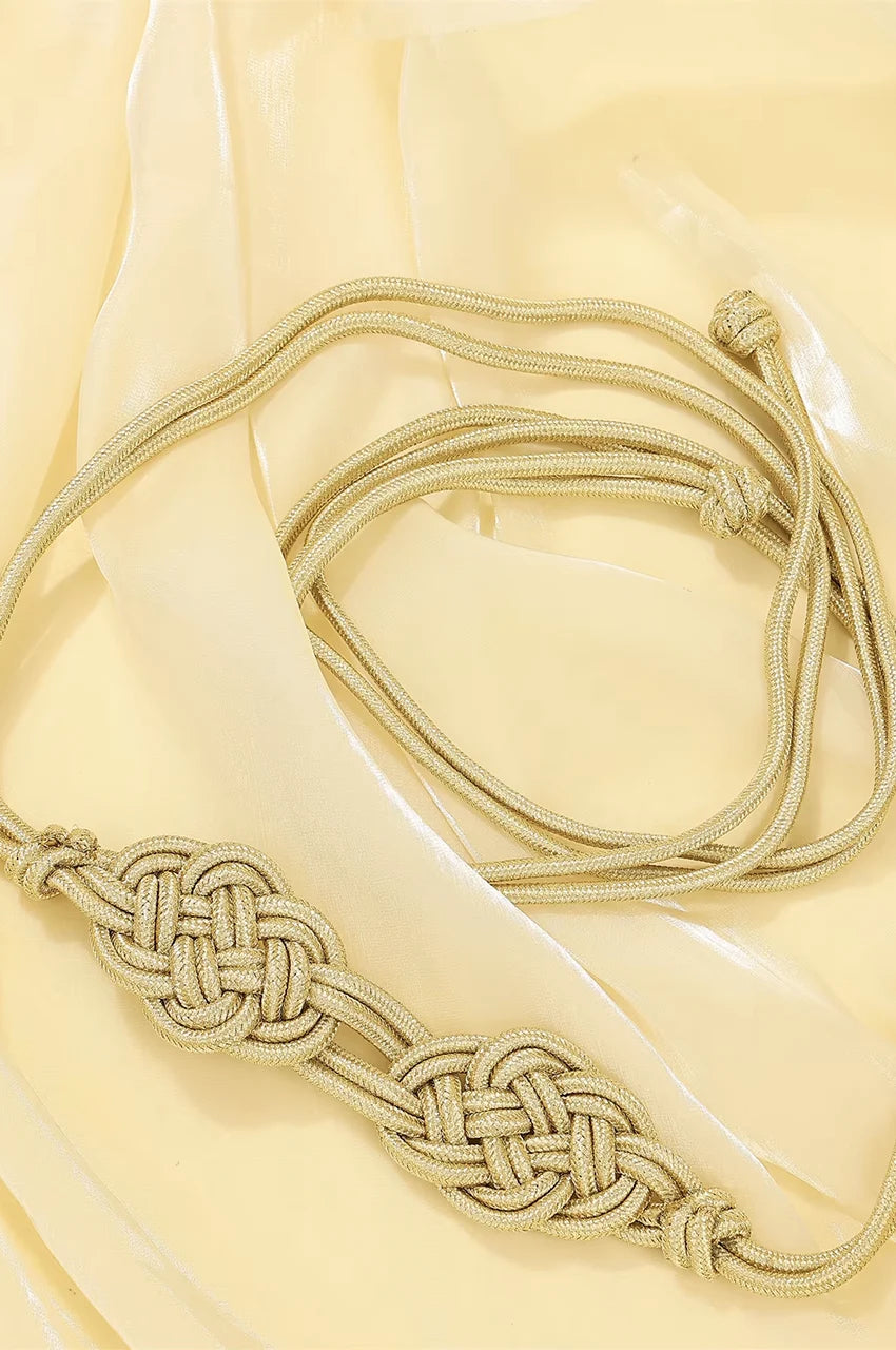 Artistic coiled display of the gold braided rope belt showing texture and flexibility.