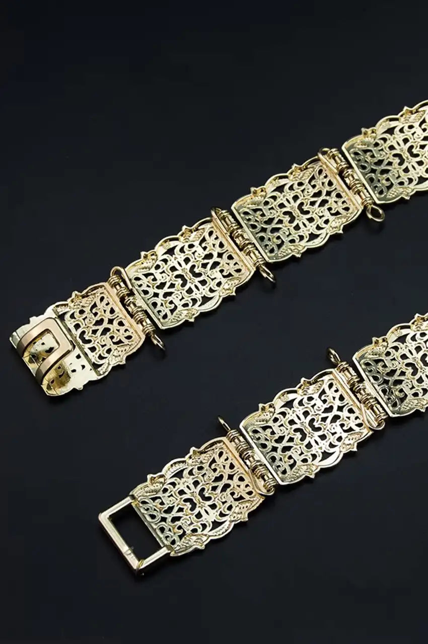 Detail of the back metal hook closure and adjustable links on the gold filigree belt.