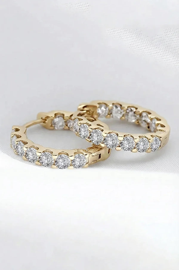 Detailed macro shot of gold vermeil hoop earrings showing the hinge closure and stone brilliance.