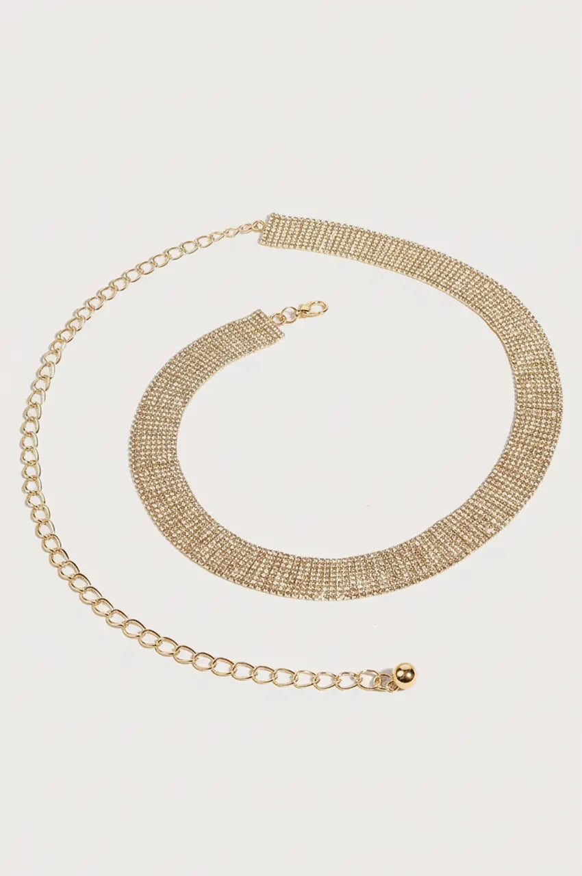 Top-down view of the gold crystal belt coiled to demonstrate mesh fluidity.