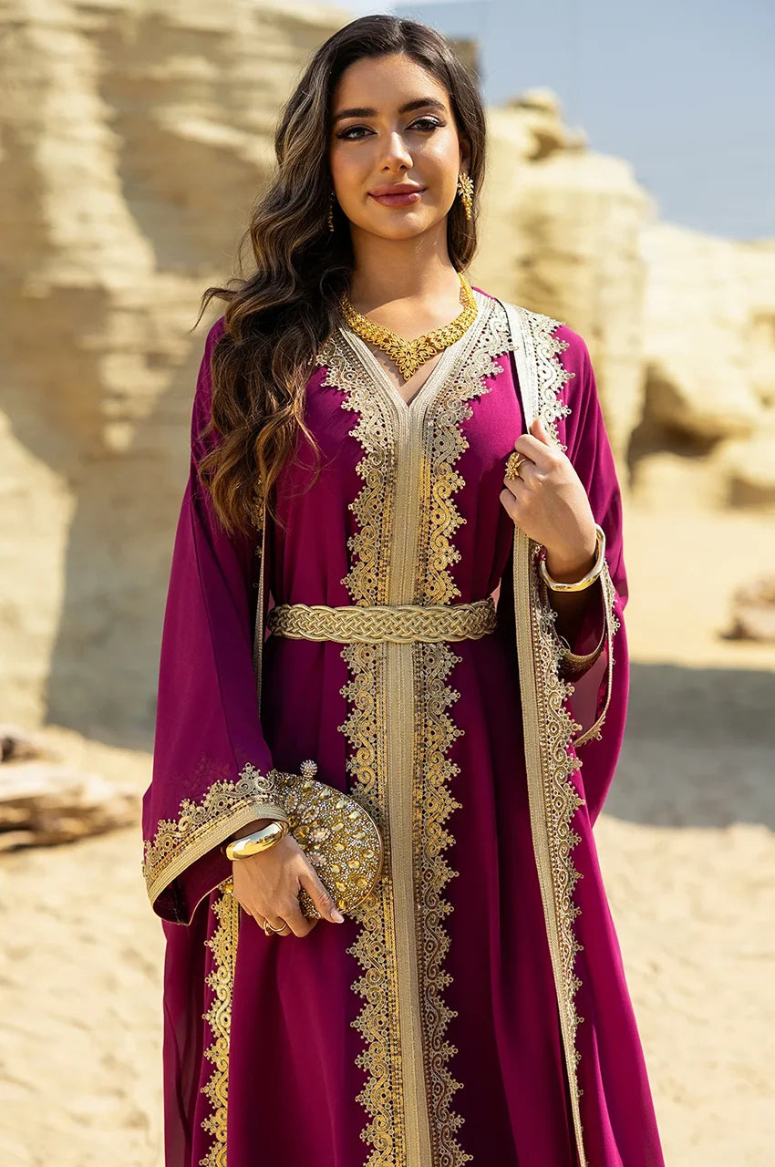 Detailed view of the gilded Sfifa lace framing the V-neck of the hot pink long sheer kaftan.