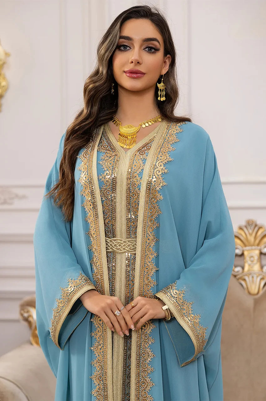 Close-up of the ornate gold Sfifa braiding on the neckline of the sky blue long sheer kaftan.