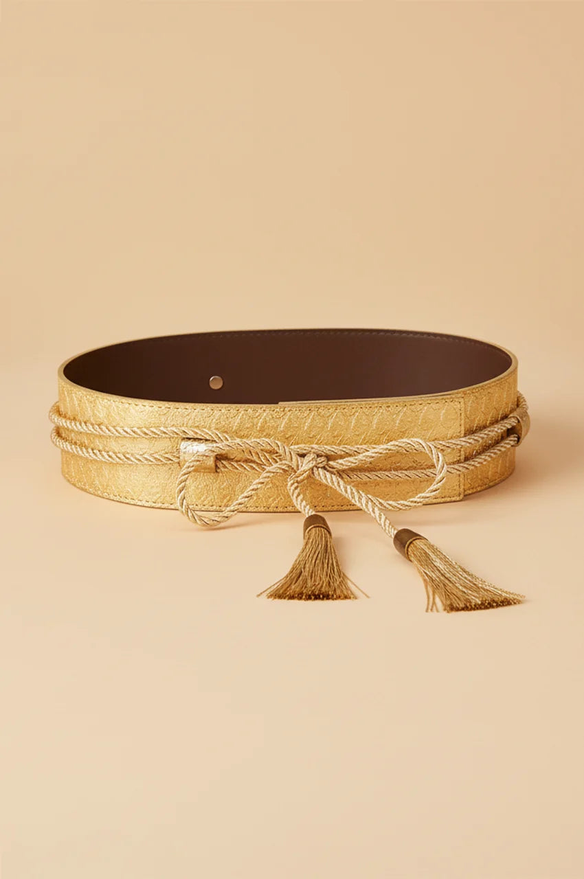 Flat lay view of gold metallic snake print waist belt with brown lining and rope ties.
