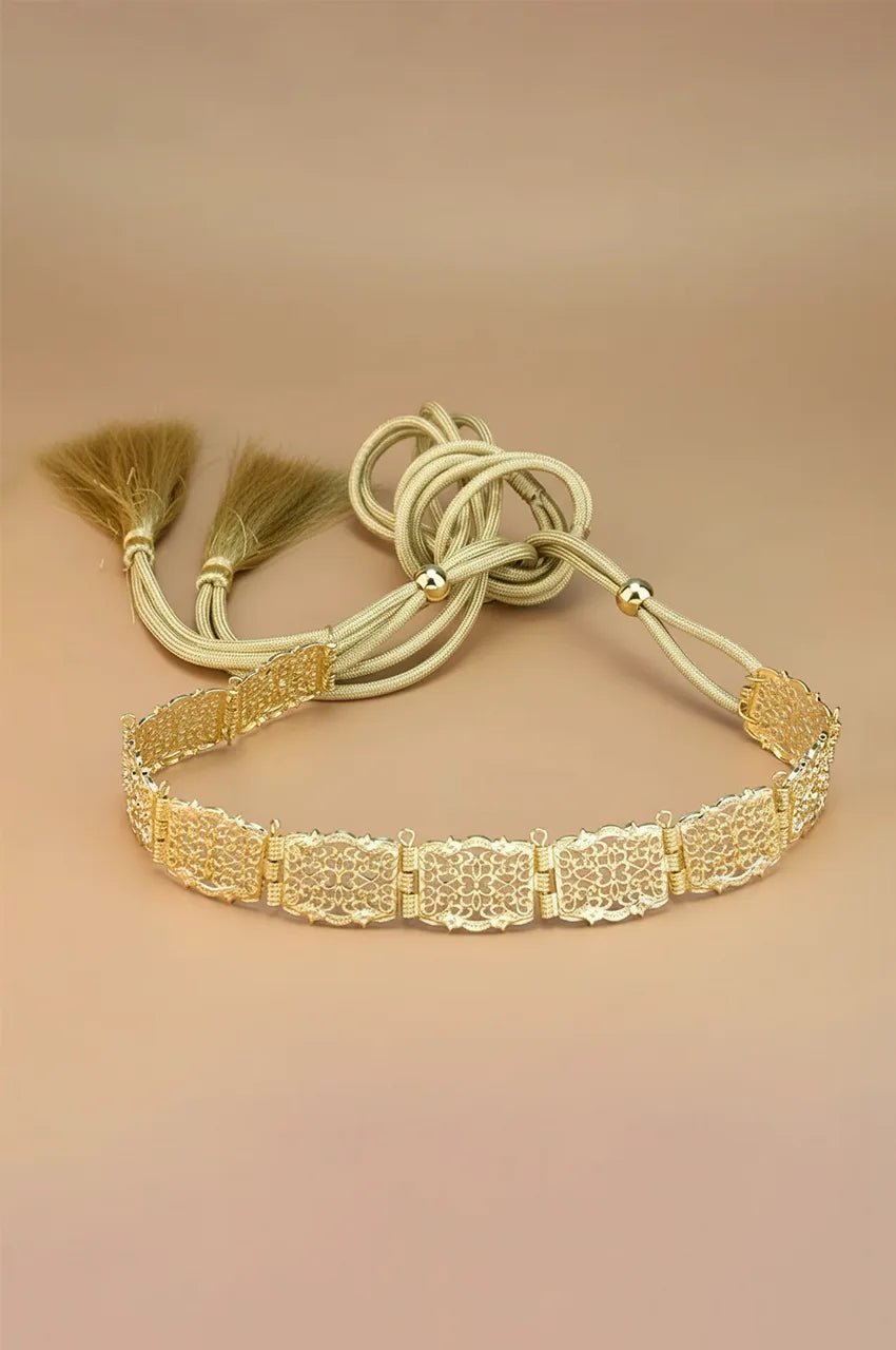 Full view of the gold square filigree belt with adjustable braided rope ties and tassels.