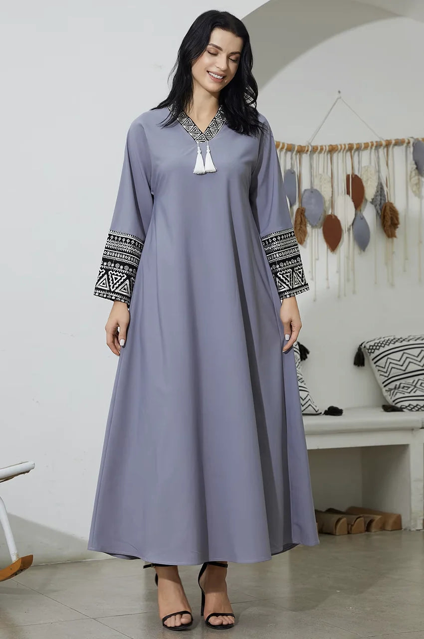 Elegant gray kaftan with black and white tribal embroidery details.