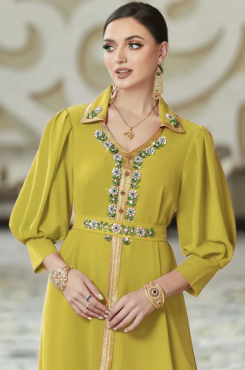 Detailed view of the Karia green kaftan bodice highlighting the crystal-embellished collar and traditional gold sfifa placket.