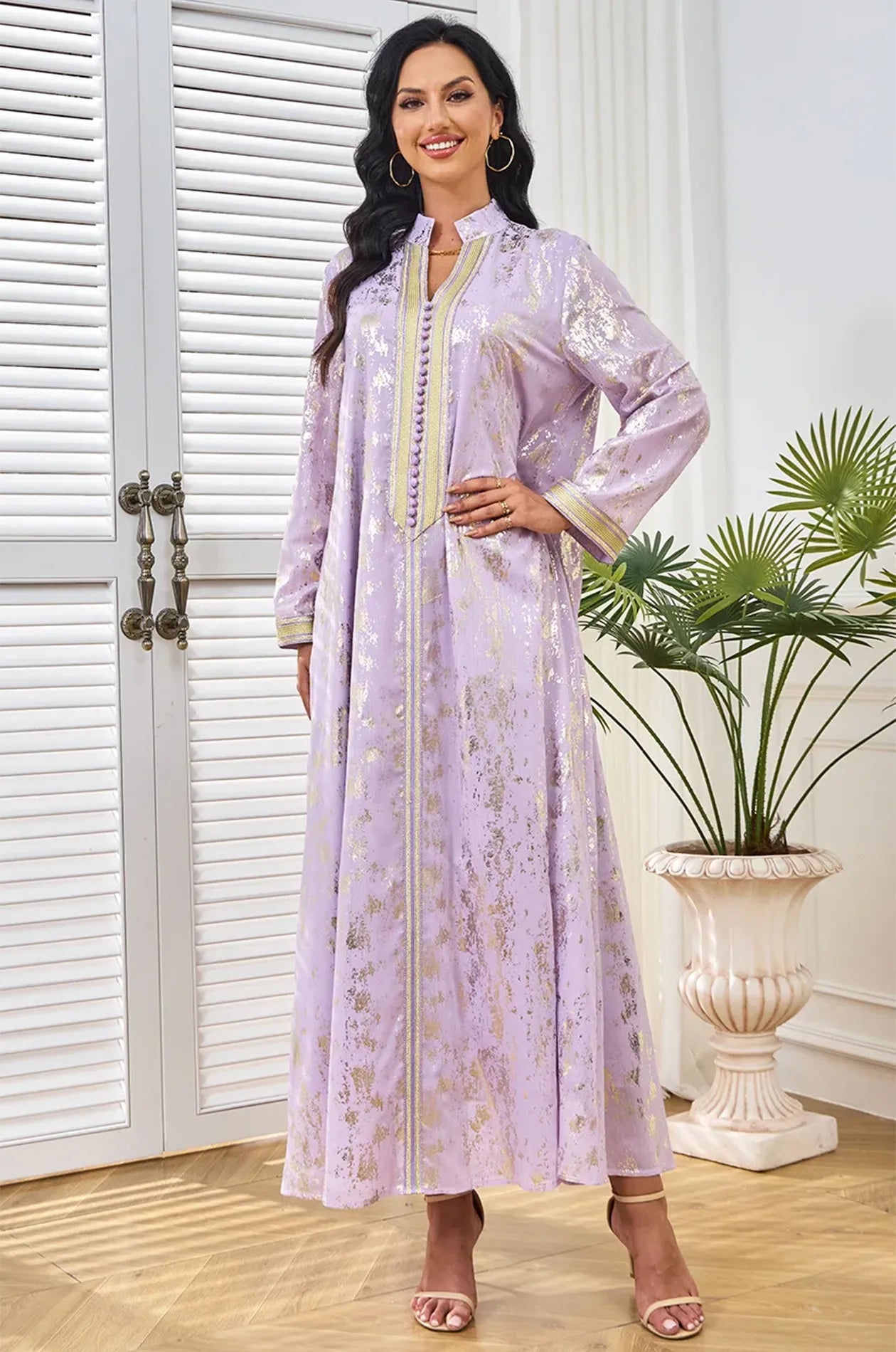Fashion model wearing the lilac Halim kaftan in an elegant room setting.