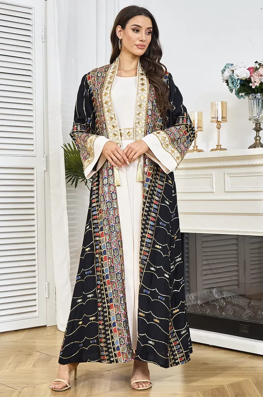 Wide kimono-style sleeves with heavy embroidered cuffs on the black plus size sequin kaftan.