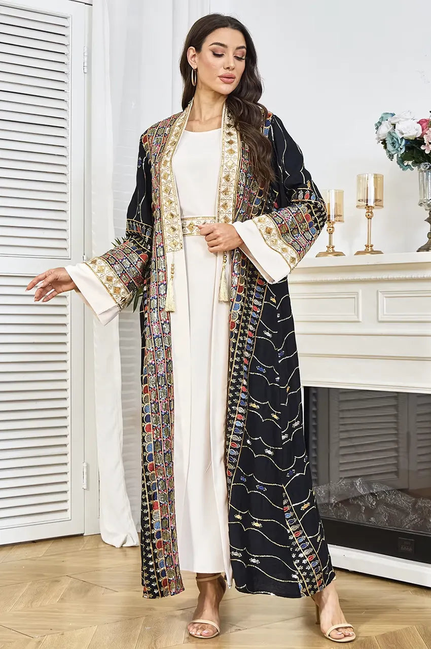 Detailed view of the adjustable gold and white rope tassel belt on the black plus size sequin kaftan.