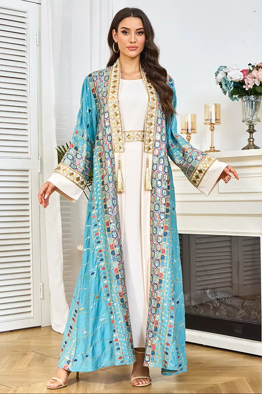 Detail view of the wide-cut sleeves and embroidered cuffs on the sky blue plus size sequin kaftan.