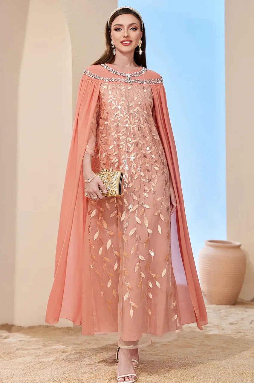 Model walking in Ilana Peach Goddess Cape Kaftan