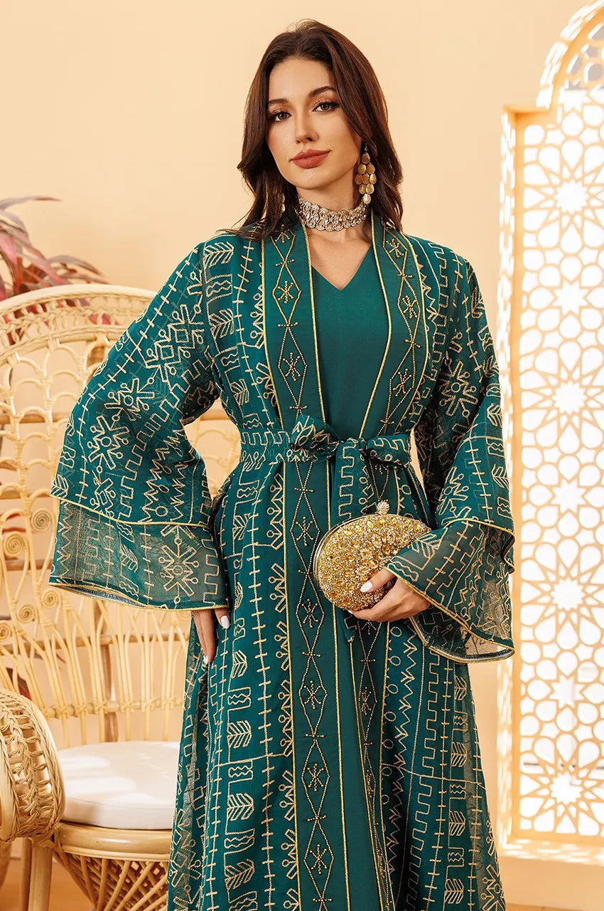 Detail view of the V-neckline on the ILYAH emerald green embroidered belted kaftan dress.