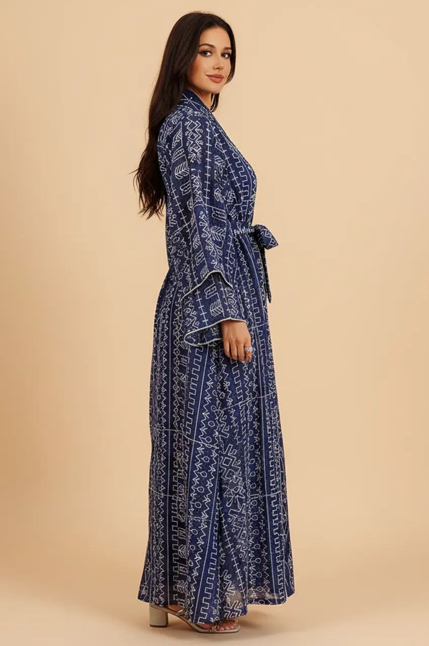Side profile view of the Ilyah midnight blue mbroidered belted kaftan dress showing sheer wide sleeves and geometric embroidery.