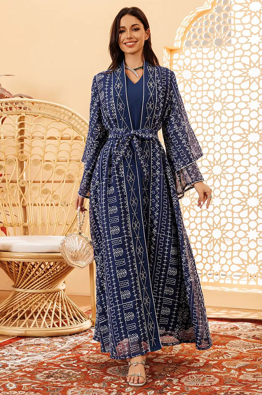 Full body shot of the Ilyah midnight blue kaftan dress in movement showing the flow of the sheer overlay.